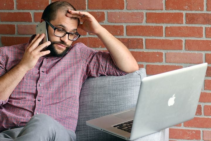 Photo of frustrated consumer trying to fix a credit report error depicting how Schlanger Law Group may help