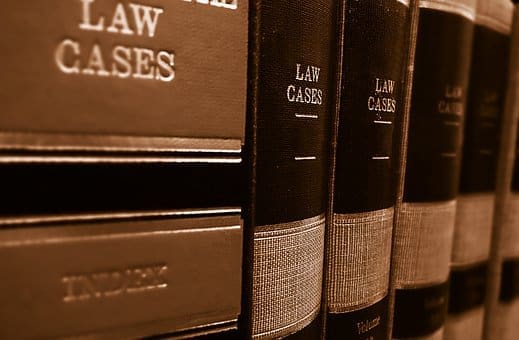 A Stack of Law Cases Books With Gold Color Image