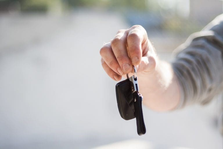 person holding out a set of keys